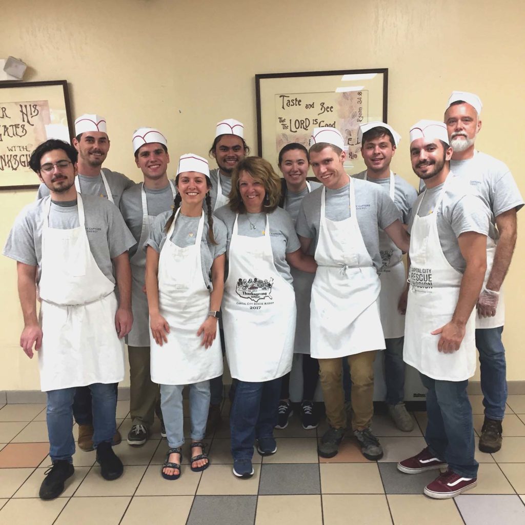 Group of employees with apron's and chef hats on.