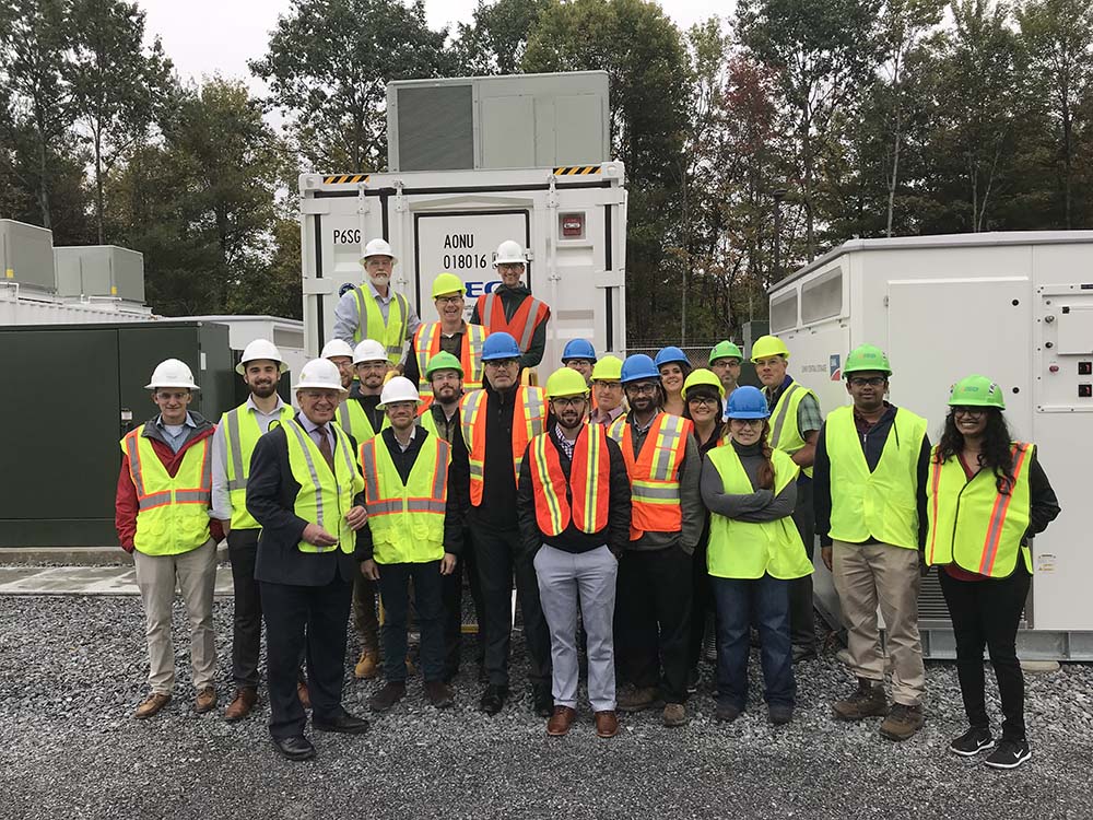 Group of employees posing for a photo at a storage site.