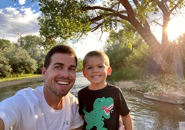 Father and son by a creek.